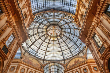 Glass dome inside the Galleria Vittorio Emanuele II in Milan. This gallery is one of the world's oldest shopping malls, completed in 1877, a true masterpiece of architecture - obrazy, fototapety, plakaty