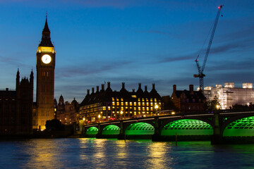 Big Ben, Parliament, and Westminster bridge on River Thames at dusk, in London, the UK