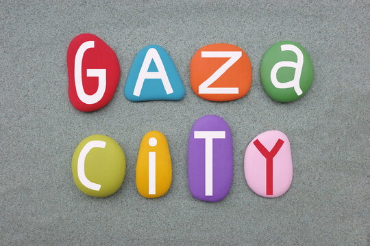 Gaza City, Palestinian city in the Gaza Strip, creative logo composed with multi colored stone letters over green sand