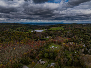 Aerial view of the countryside in Stormville, NY on a cloudy day during the colorful autumn season...