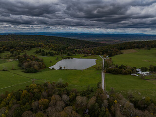 Aerial view of the countryside in Stormville, NY on a cloudy day during the colorful autumn season...