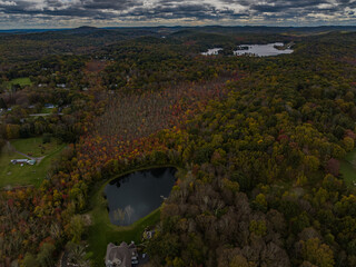 Aerial view of the countryside in Stormville, NY on a cloudy day during the colorful autumn season...