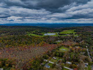 Aerial view of the countryside in Stormville, NY on a cloudy day during the colorful autumn season...