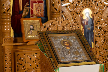 Orthodox icons on a church pulpit. When worshipers enters the church they will kiss this icon and...