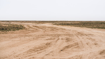 Fototapeta na wymiar The international highway in Uzbekistan is of very poor quality, an old road in the desert