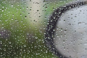 Lots of raindrops on the window. Rainy season concept. Climate change. Wet in rain. Focus on water droplets on window.
