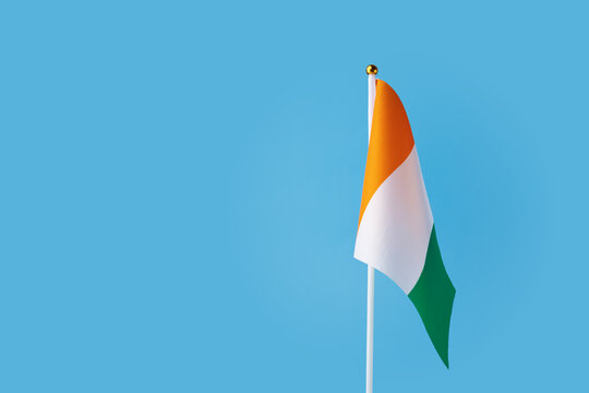 cote d'ivoire flag on a blue background, copy space, independence national day of cote d'ivoire, country freedom, patriotism - Powered by Adobe