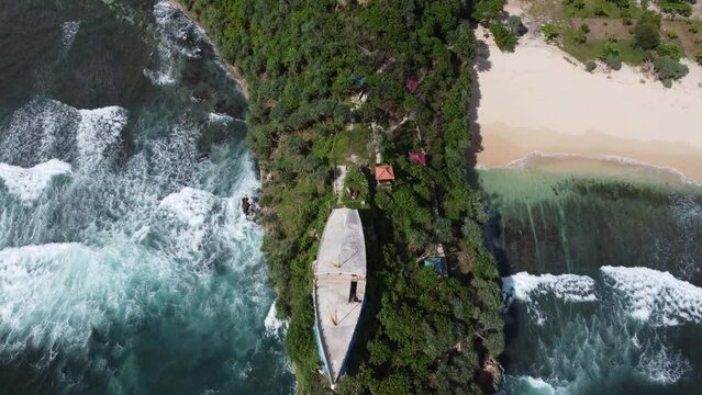 Aerial for A boat on a hill at Watu Leter Beach, Java Island, Indonesia
