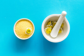 White mortar with pharmacy chamomile flowers for skin care spa products