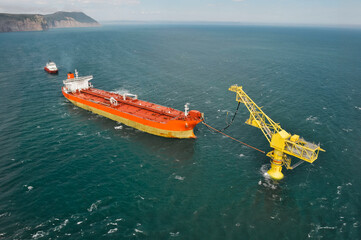 An oil tanker pumps oil to a special offshore oil receiver for the De Castries oil terminal