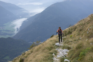 Fototapeta na wymiar Woman Hiking from the valley to the top of mount Krn - Julian Alps Slovenia 