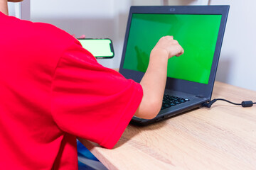 Asian boy stay at home while watching something on laptop