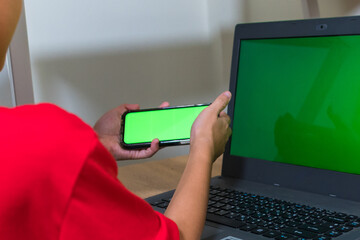 Asian boy studying online on digital tablet on desk at home. Copy space. No change. Childhood,...