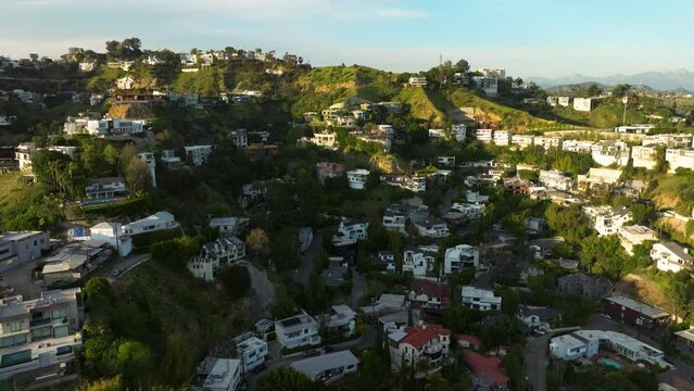 Drone flying towards luxurious mansions on Hollywood Hills in Los Angeles. luxury residences and villas in Hollywood Hills. 