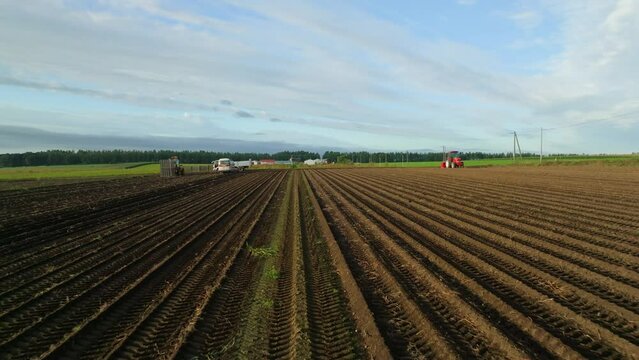 Flying fast and low over plow tracks in soil on farm in morning light