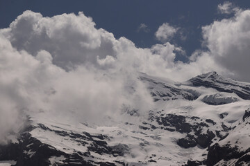 Snowy Mountains Covered in Fluffy Clouds