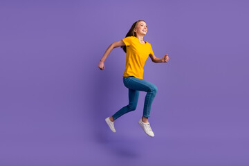 Fototapeta na wymiar Full length photo of girl having fun jumping up running speed isolatedpurple color background