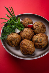 Hot, Juicy Beef Meat Patties on a Plate against a Red Background