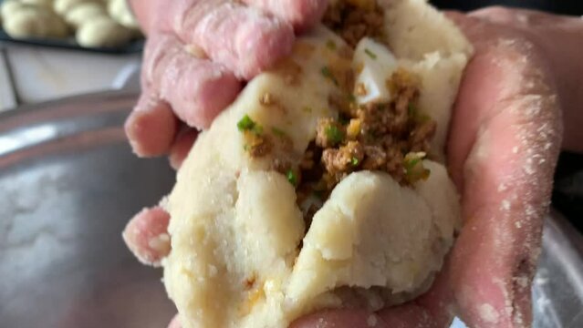 Video of the preparation of "Papa Rellena". traditional Peruvian food made with potatoes. Concept of food.