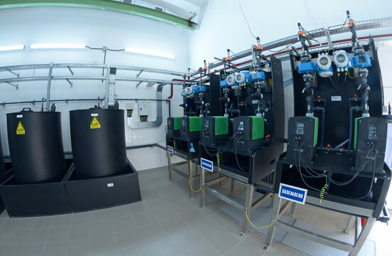 At the dosing systems hall of the water pumping station: sodium hypochlorite storage tanks and dosing system made Grundfos