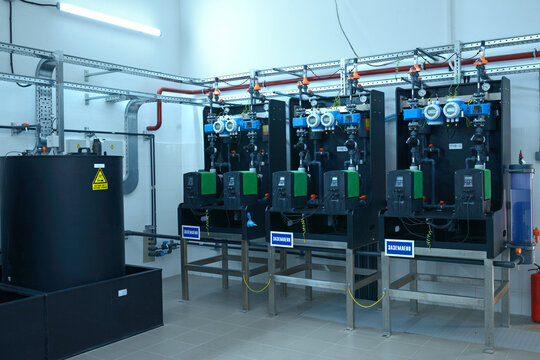 At the dosing systems hall of the water pumping station: sodium hypochlorite storage tanks and dosing system made Grundfos