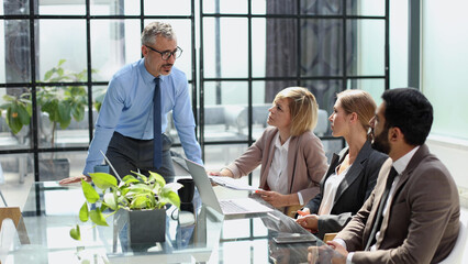 Portrait of creative business team using laptop