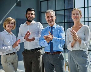 Business people stand with each other in front of a modern office