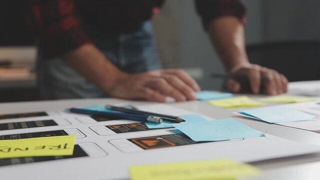 UX graphic designer planning application process development prototype wireframe for web smart phone. Creative digital development agency. in office