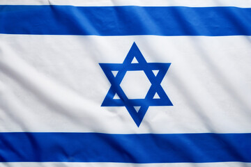 Israel flag. Independence Day of Israel. Israel flag beautifully waving wave with star of David over white wooden background. National pride of Israel. Patriotism and commonwealth. Top view. Mock up.