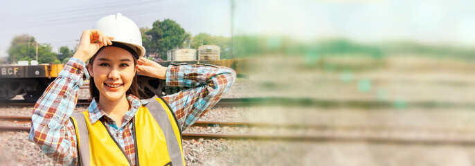Portrait beautiful professional asian female engineer working in the field outdoors at the garage diesel locomotive train station smiling at the camera graceful pose : Banner with copy space.