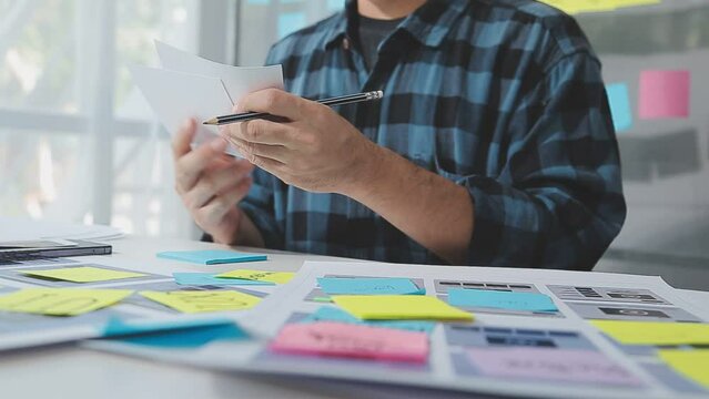 UX graphic designer planning application process development prototype wireframe for web smart phone. Creative digital development agency. in office