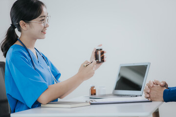 A male patient visits a female doctor at the clinic. Medical worker writes prescriptions on the...