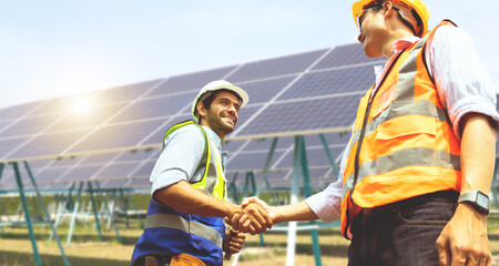 Caucasian male architect and Asian engineer electrician shaking hands working colleagues team...