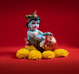 Hindu God Krishna on red background indian dahi handi festival