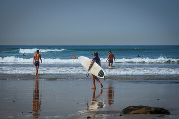Surfers on the beach of Las Palmas in Gran Canaria