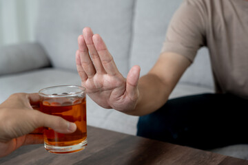 man refuses say no and avoid to drink an alcohol whiskey , stopping hand sign male, alcoholism...
