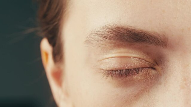 Nervous tic. Obsessive-compulsive disorders. Patient of a psychiatric clinic. Woman biting lips, scratch face, biting nails, eye twitching. Close up, macro. 