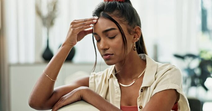 Depression, woman and thinking in home of pain, mental health or anxiety of debt, fatigue or regret mistake. Stress, doubt and confused indian girl with headache of trauma, broken heart or sad memory