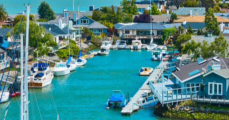 Water canal in Paradise Cay Yacht Harbor with boats beside waterfront properties aerial