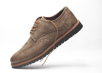 Levitating leather brogue shoe on a white background