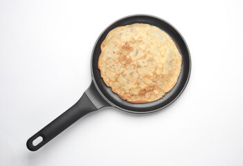 Frying pan with pancakes on white background. Top view