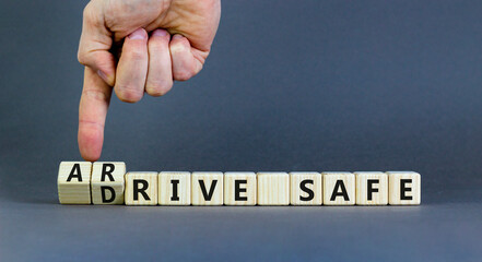 Drive and arrive safe symbol. Concept words Drive safe Arrive safe on wooden blocks. Beautiful grey table grey background. Businessman hand. Business drive and arrive safe concept. Copy space.