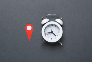 Alarm clock and Geolocation Maps Marker point icon on dark gray background.