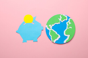Paper-cut piggy bank with coin and globe on pink background