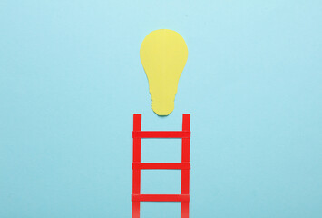 Paper red stairs and light bulb on blue background. Creative idea. Business concept