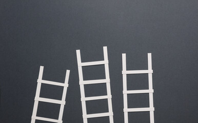 White paper stairs on dark gray background. Business concept