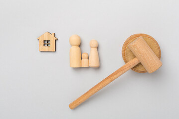 Wooden family figures with judge's gavel on color background,top view