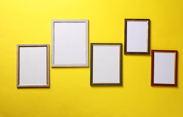 Blank wall frames on yellow background