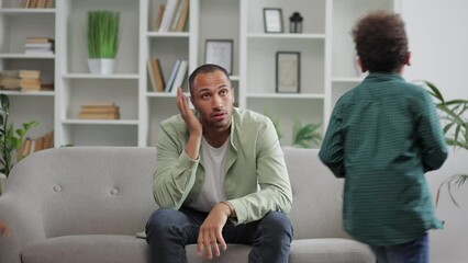 Irritated depressed caucasian man sad tired father feel stress headache due annoying active little child naughty boys disturb male parent babysitter. - Powered by Adobe