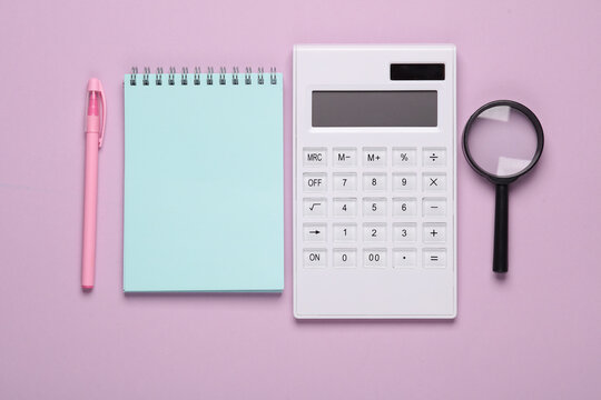 Calculator notepad and magnifier on a pastel background. Education, back to school. top view
